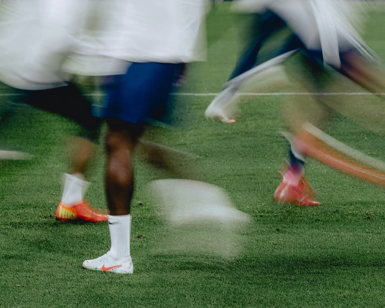 Soccer players running on the field